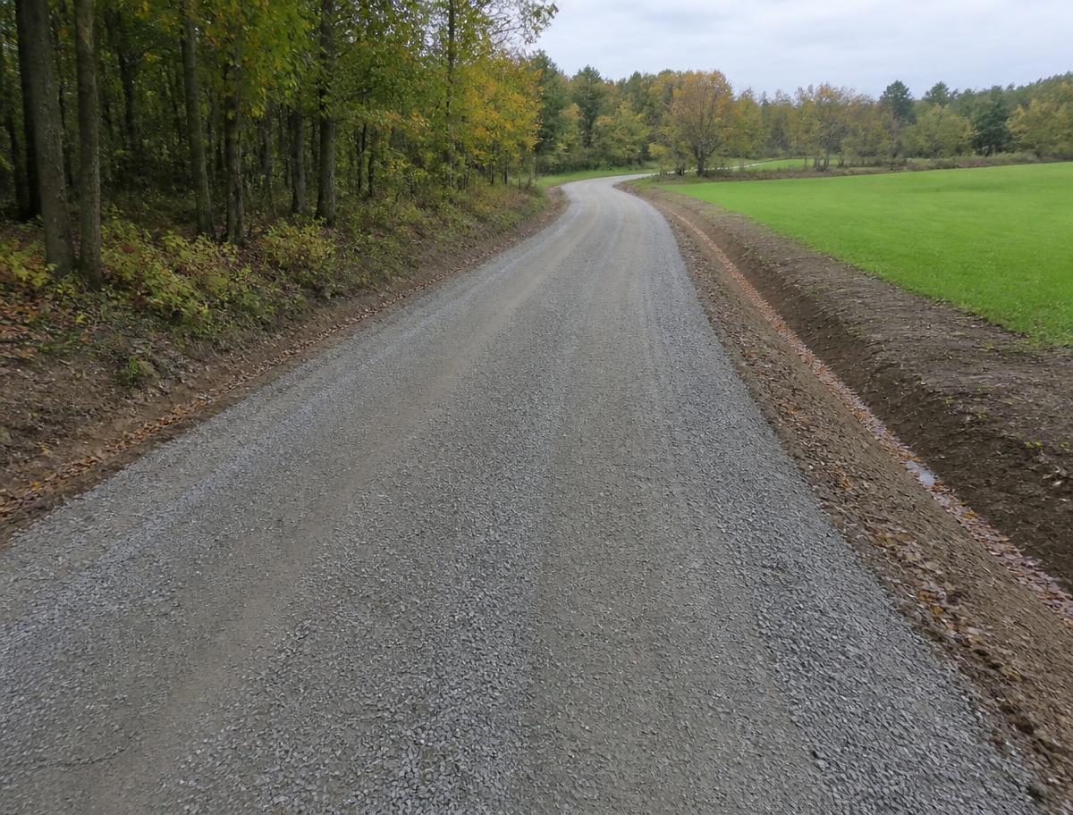 Smooth restored gravel driveway with a clean crown and defined edges